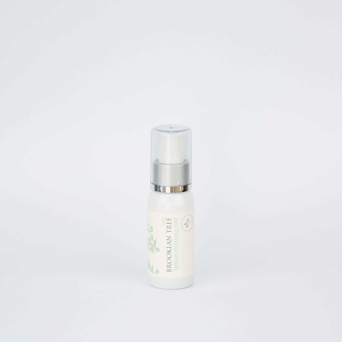 Skincare serum bottle with green leaves on a light green background change leaves
